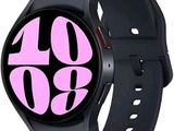 a black smart watch with a pink logo on it