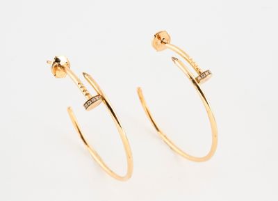 a pair of gold hoop earrings with diamonds on them