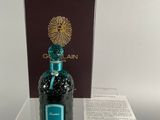a bottle of perfume sitting on a table next to a box