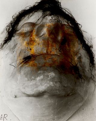 an old photograph of a man ' s face with hair on it