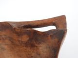 an old wooden bowl with a handle on a white background