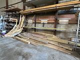 many pieces of wood stacked on the floor in a warehouse