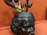 une statue d'un homme avec des clubs de golf dans la tête