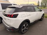 the rear end of a white suv parked next to a white van