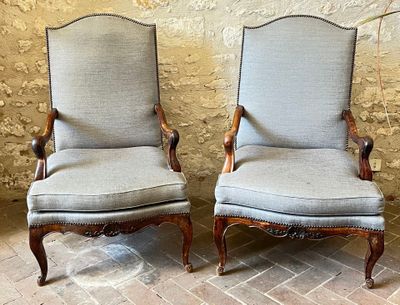 two chairs sitting next to each other on a brick floor