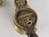 a close up of a brass object on a white surface