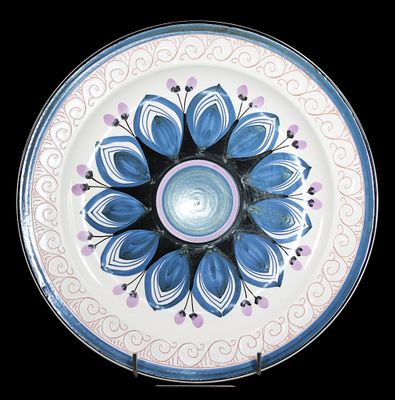 a blue and white plate with a flower design on it