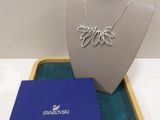 silver plated necklace with a blue box on a white table