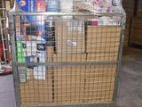 a metal cart with several boxes on it in a warehouse