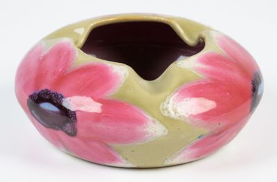 a vase with a flower design on it on a white surface