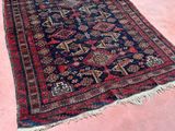 an old persian rug on a pink floor in a room