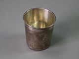 a silver cup that is sitting on a table