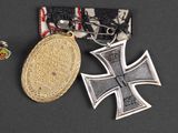 two medals and a medal on a black surface