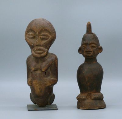 pair of old wooden figurines of a man and a woman