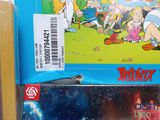 two books that are on a shelf with a sticker