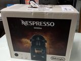 a box of nespresso coffee machine sitting on a table