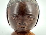 an image of a wooden sculpture of a woman ' s head