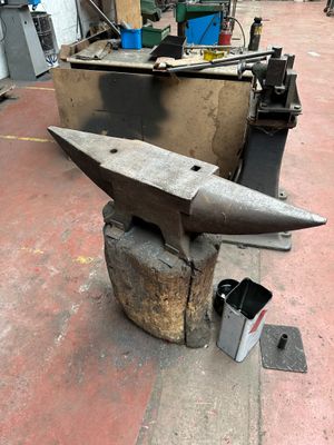 an anvil sitting on top of a piece of metal