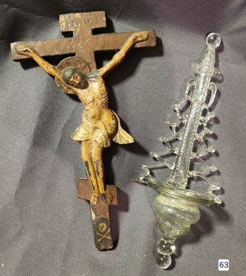 a crucifix and a glass vase on a table