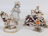 three porcelain figurines of women and children on a white background