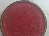 a small red piece of fabric on a white surface