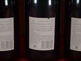 three bottles of wine sitting on top of a table next to each other
