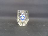 a shot of a shot glass with a blue star on it