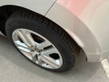 a close up of a car ' s tire on the street