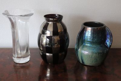 three vases sitting on a table next to each other