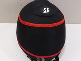 a black and red speaker sitting on a white table