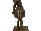 bronze statue of a little girl in a tutu skirt
