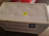 a white box with a yellow sticker on it sitting on the floor