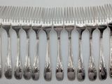 a lot of forks and spoons that are on a table