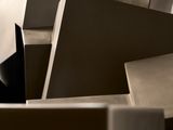 a man that is standing in a room with a bunch of boxes