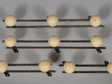 a set of eight wooden ball hooks on a wall