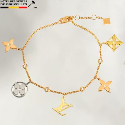 a close up of a gold bracelet with charms on it