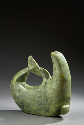 an image of a green sculpture of a fish on a gray surface