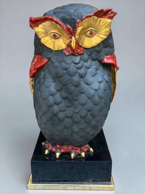a statue of an owl that is sitting on a pedestal