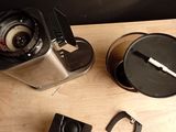 a coffee grinder and a cup on a wooden table