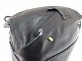 black leather handbag with gold studded handles on a white background