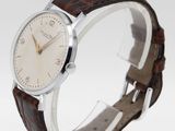 an image of a close up of a wrist watch on a stand