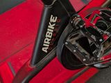 a close up view of a bike with a red seat