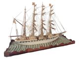 a model of a ship on display on a white surface