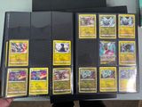 a person holding a bunch of cards on a table