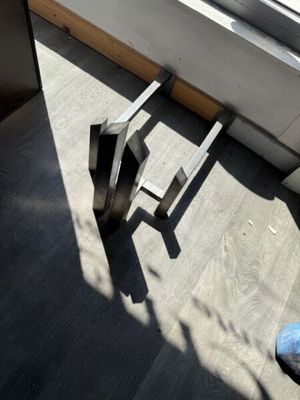 a pair of blue shoes sitting on the floor next to a window