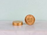a gold coin sitting on top of a marble table