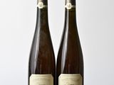 deux bouteilles de vin posées l'une à côté de l'autre sur une table en bois