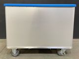 an image of a white and blue cart sitting on top of a cement floor