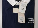 the polo shirt is blue and white with a tag on it