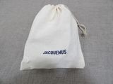 a bag with a name on it sitting on a bed